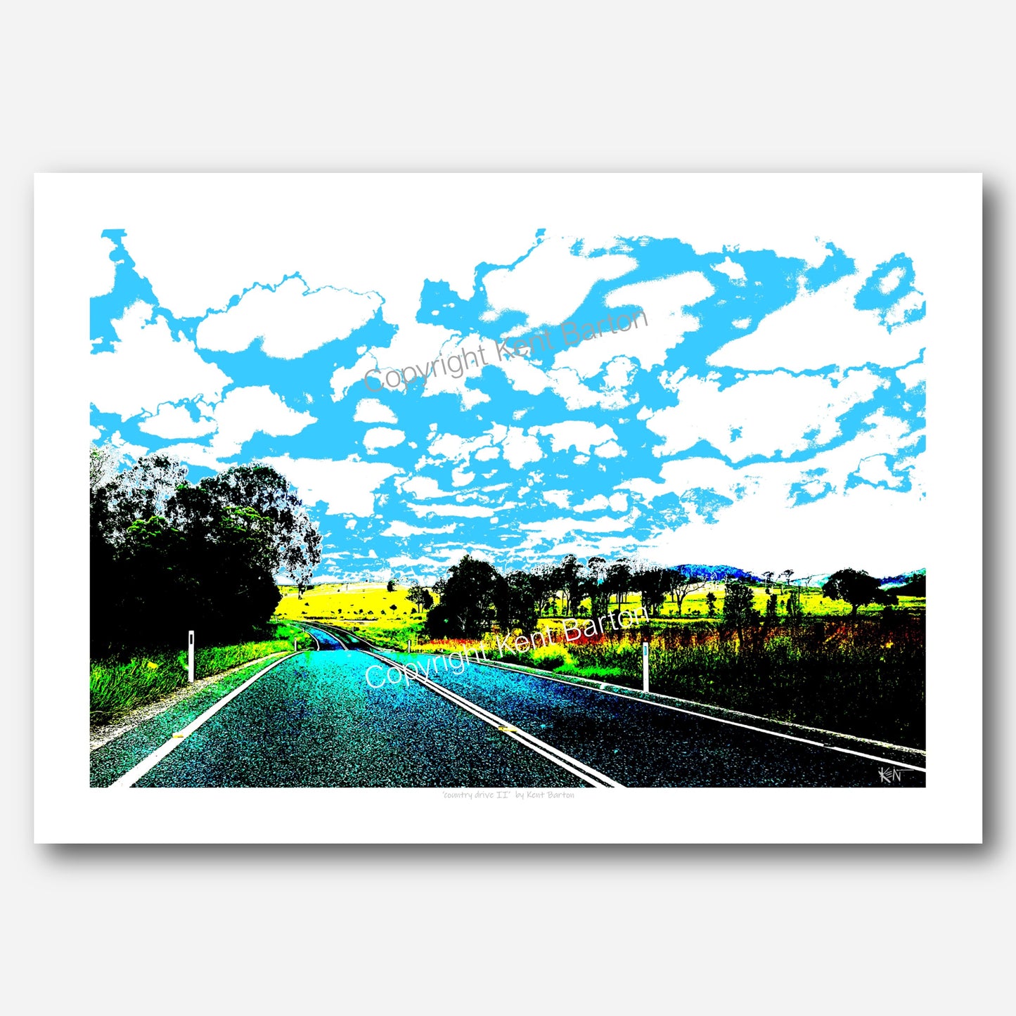 "A country road dips and turns off to the left surrounded by fields and trees and a huge sky."
