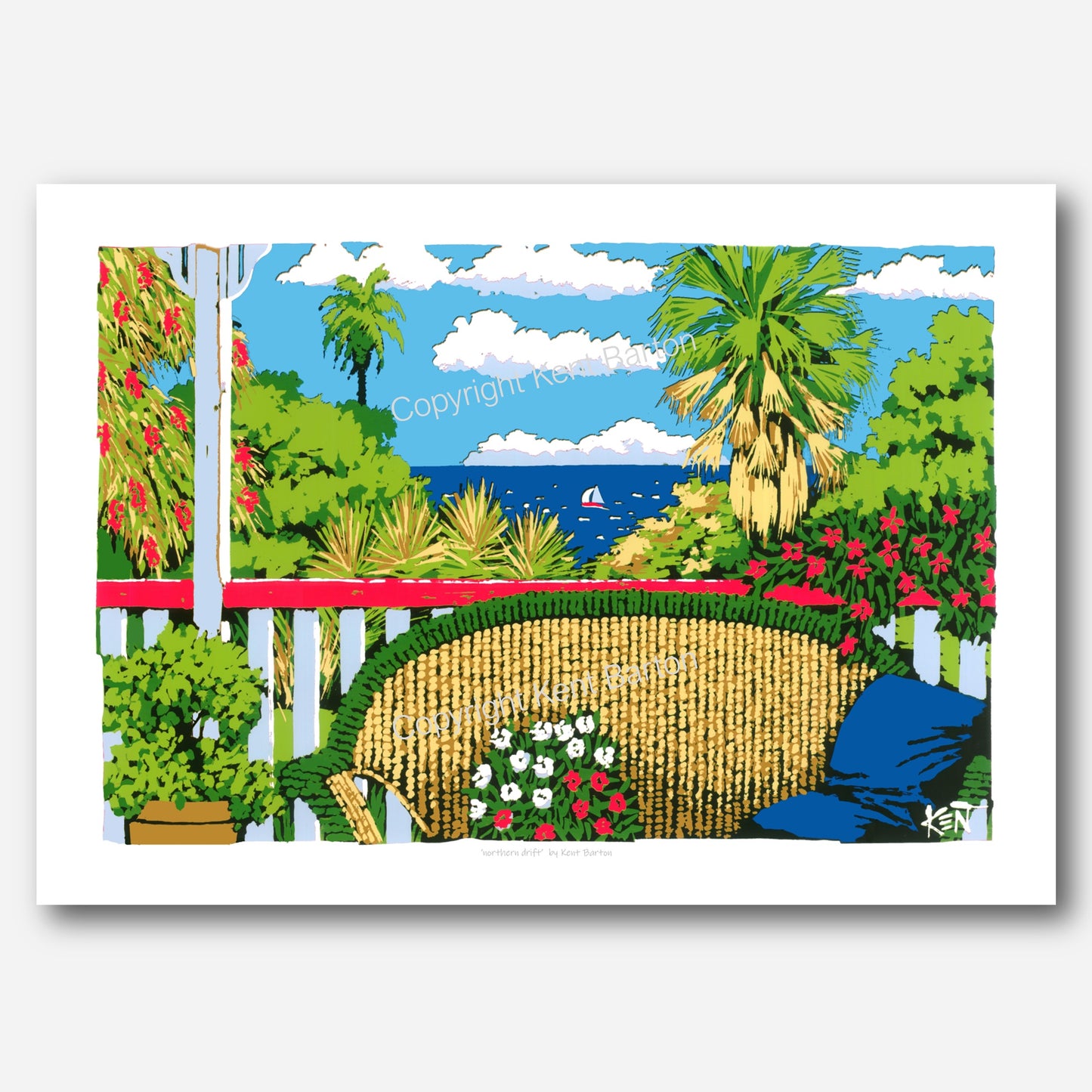 "A cane lounge on a timber veranda with views over tropical forest to a sailing boat on the ocean."