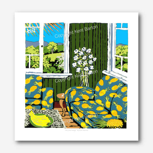 "Lounge suite upholstered in pineapple print design, views out the windows of trees and hills."